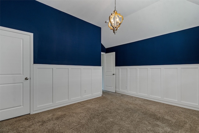 unfurnished room with vaulted ceiling, light colored carpet, and an inviting chandelier