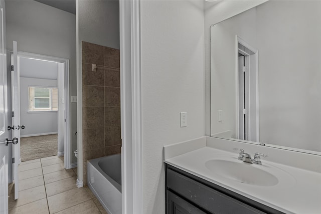 bathroom with vanity, tile patterned floors, and toilet