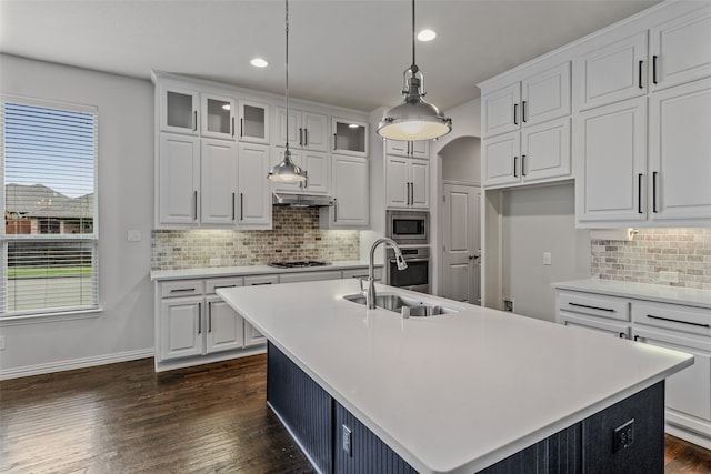 kitchen featuring white cabinetry, an island with sink, sink, and stainless steel appliances