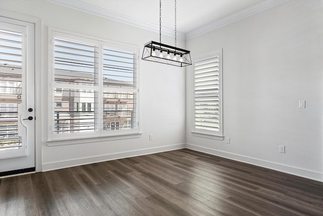 unfurnished dining area with ornamental molding, wood-type flooring, and a chandelier