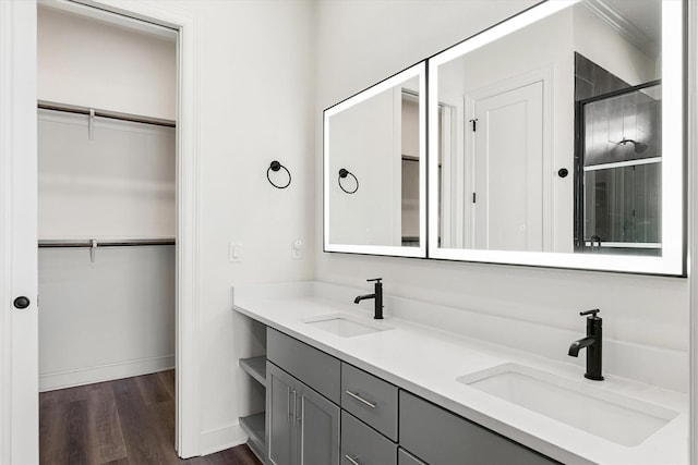 bathroom featuring wood-type flooring and double vanity