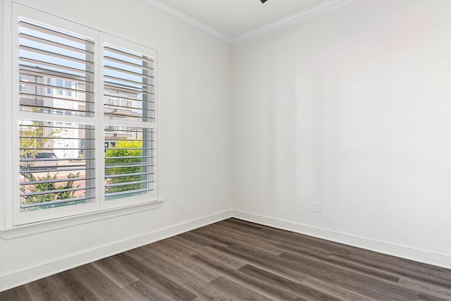 empty room featuring crown molding and dark hardwood / wood-style flooring