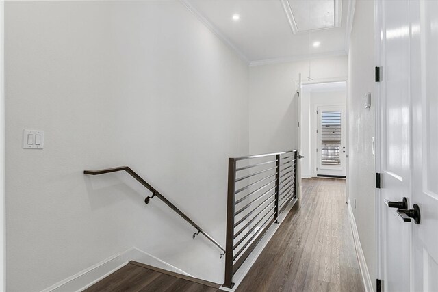 staircase with crown molding and hardwood / wood-style flooring