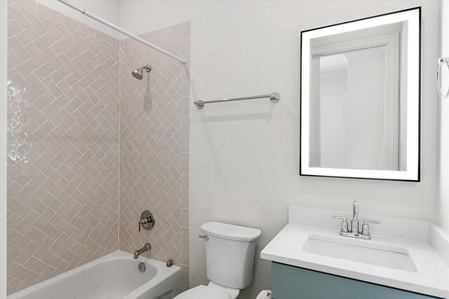 full bathroom featuring vanity, tiled shower / bath combo, and toilet