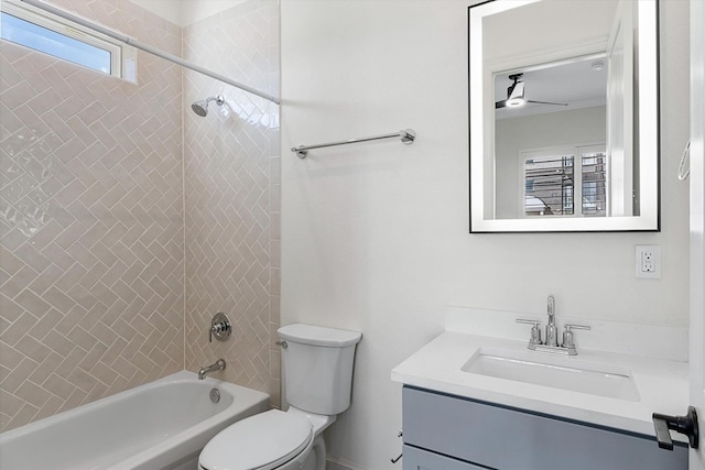 full bathroom with vanity, ceiling fan, tiled shower / bath, and toilet