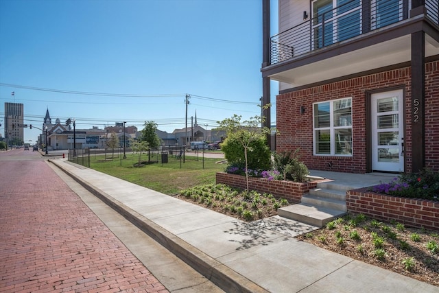 exterior space with a balcony and a yard