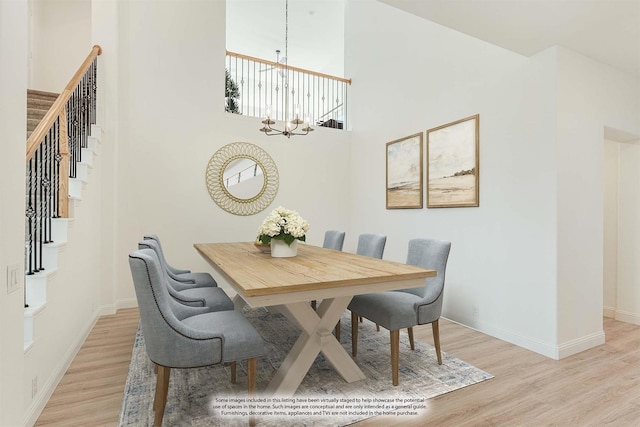 dining area with stairway, baseboards, light wood-style flooring, and a chandelier