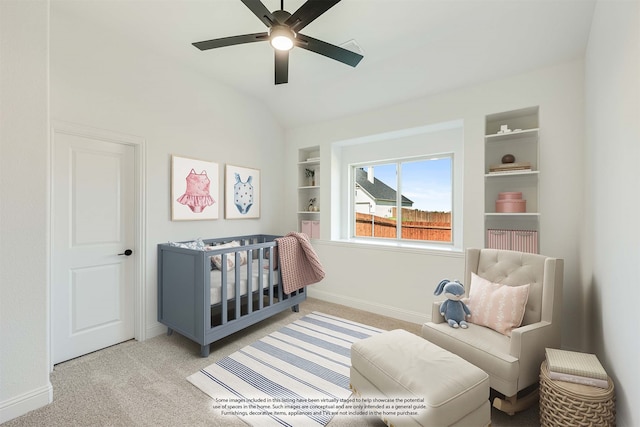 bedroom with lofted ceiling, a nursery area, light carpet, and ceiling fan