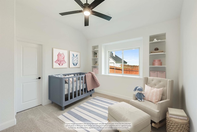bedroom featuring a ceiling fan, carpet floors, baseboards, a crib, and lofted ceiling