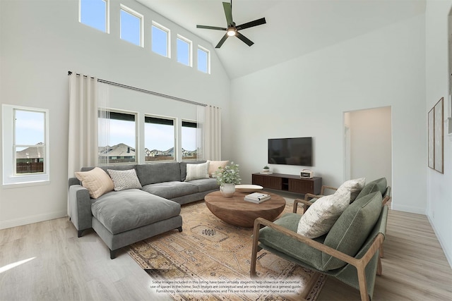 living room with light hardwood / wood-style floors, high vaulted ceiling, and ceiling fan