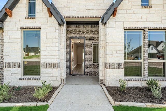 property entrance with stone siding