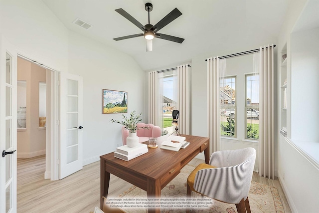 dining room with ceiling fan, visible vents, baseboards, light wood finished floors, and lofted ceiling