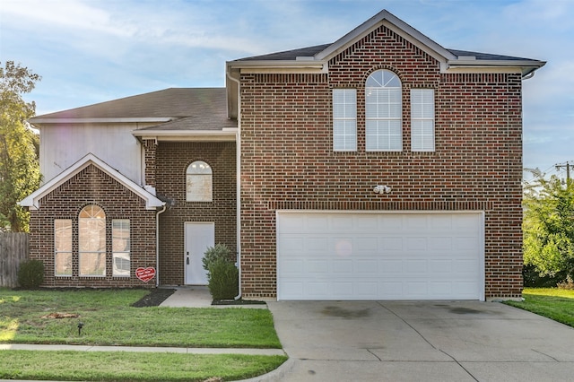 view of property featuring a garage and a front lawn