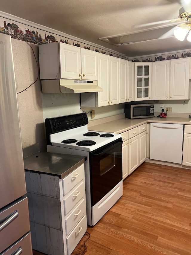 kitchen with ceiling fan, appliances with stainless steel finishes, light hardwood / wood-style floors, and white cabinetry