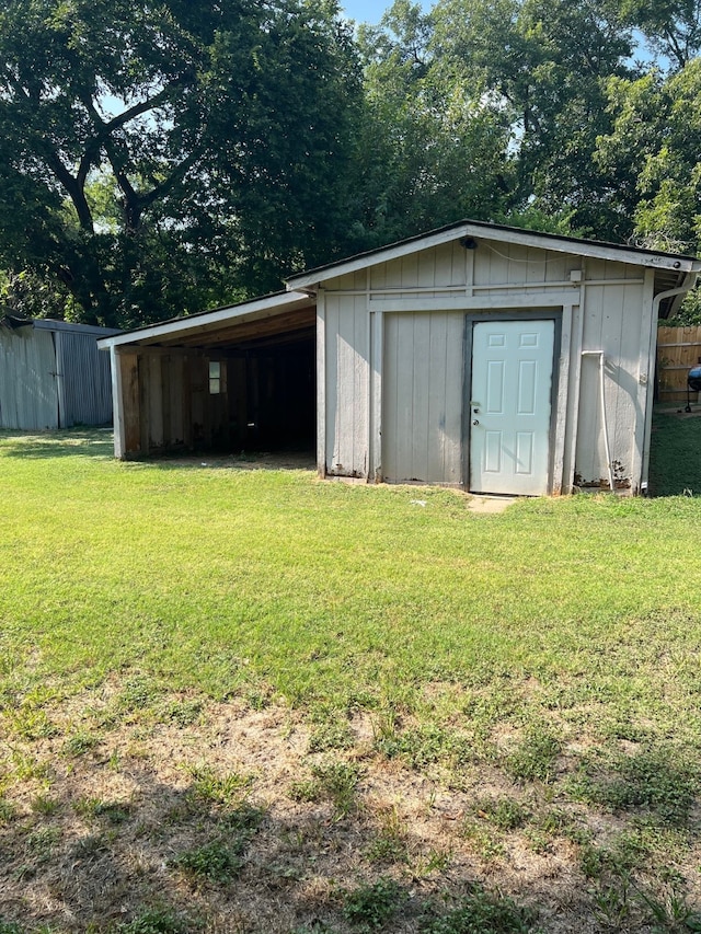 view of outbuilding featuring a lawn