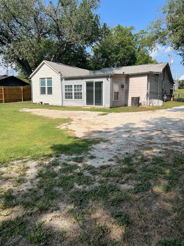 rear view of property with a lawn