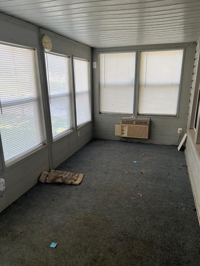 unfurnished sunroom featuring a wall unit AC