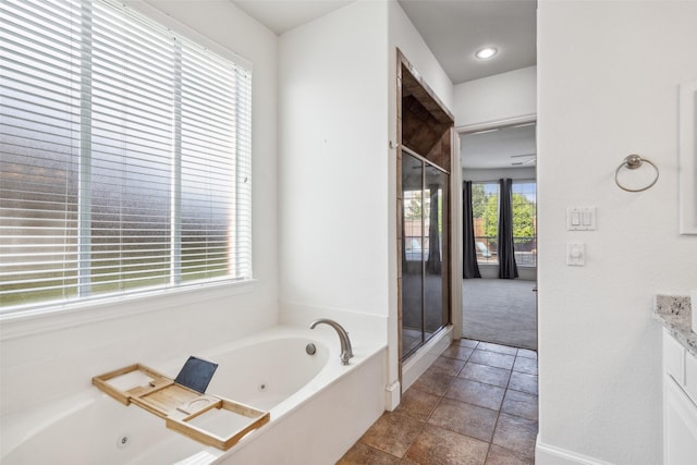 bathroom with vanity, plus walk in shower, and a healthy amount of sunlight