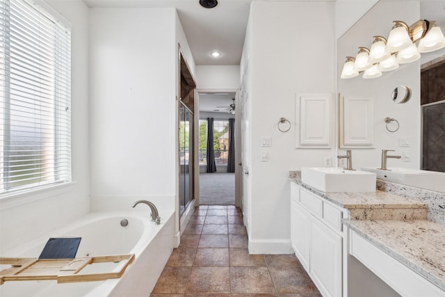 bathroom featuring vanity, shower with separate bathtub, and a healthy amount of sunlight