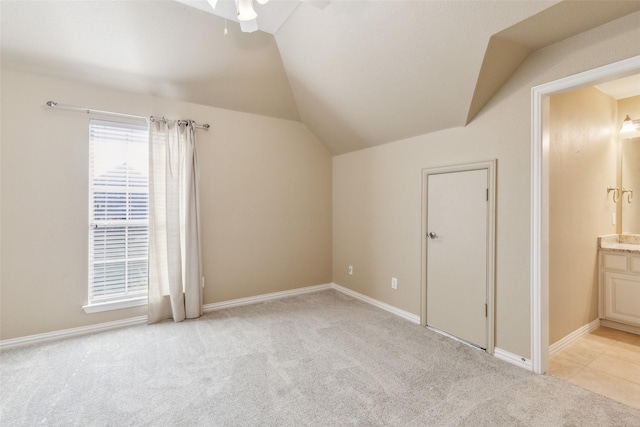 additional living space with vaulted ceiling and light colored carpet