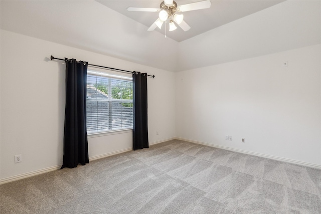 carpeted spare room featuring ceiling fan and lofted ceiling