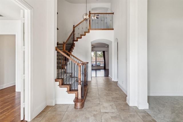 tiled entrance foyer with a chandelier