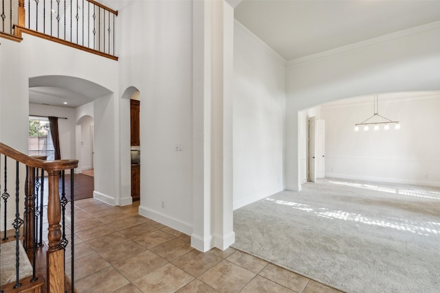 interior space featuring light carpet and ornamental molding