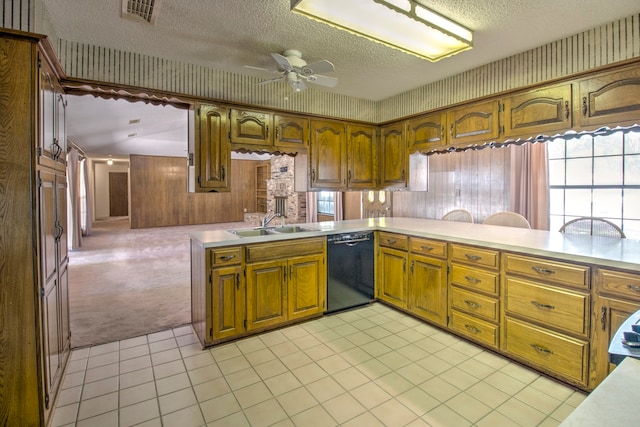 kitchen with ceiling fan, light carpet, black dishwasher, a textured ceiling, and kitchen peninsula