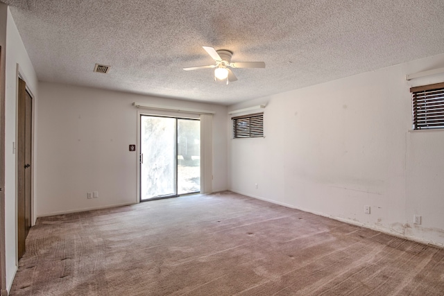 unfurnished room featuring carpet flooring, a textured ceiling, and ceiling fan