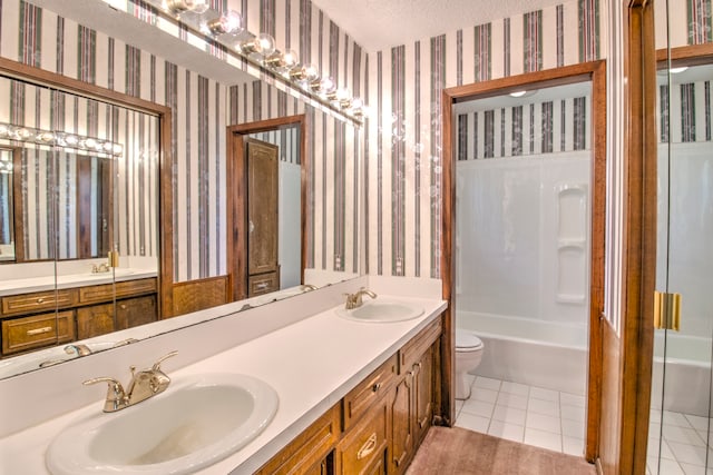 full bathroom featuring dual vanity, shower / washtub combination, a textured ceiling, tile patterned floors, and toilet