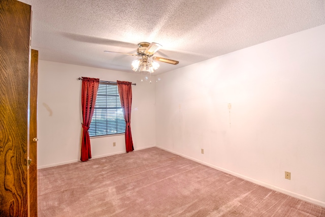 unfurnished room featuring a textured ceiling, carpet, and ceiling fan