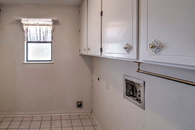 laundry area with light tile patterned flooring, washer hookup, hookup for an electric dryer, and cabinets