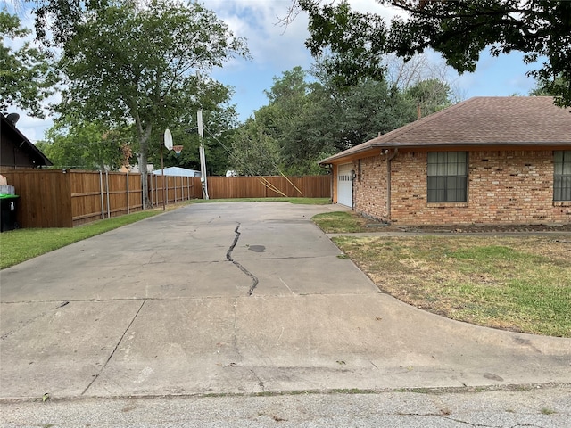 view of property exterior featuring a garage and a yard