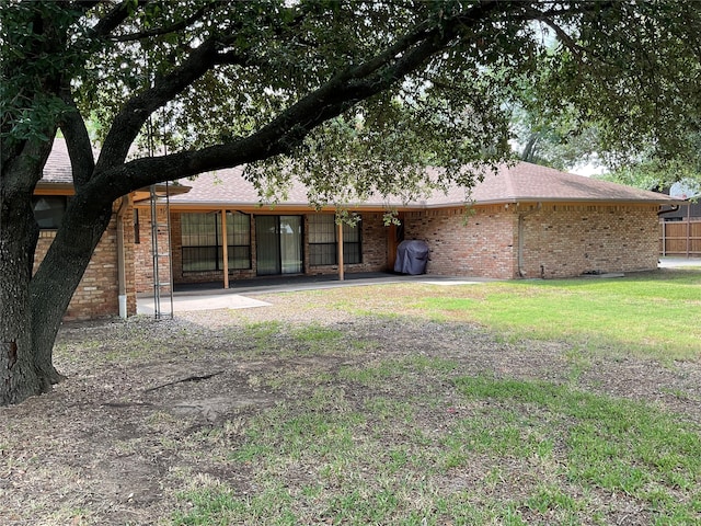 back of house with a yard