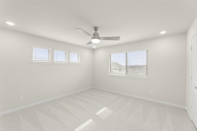 spare room featuring ceiling fan and light colored carpet