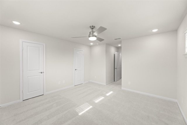 empty room with light carpet and ceiling fan