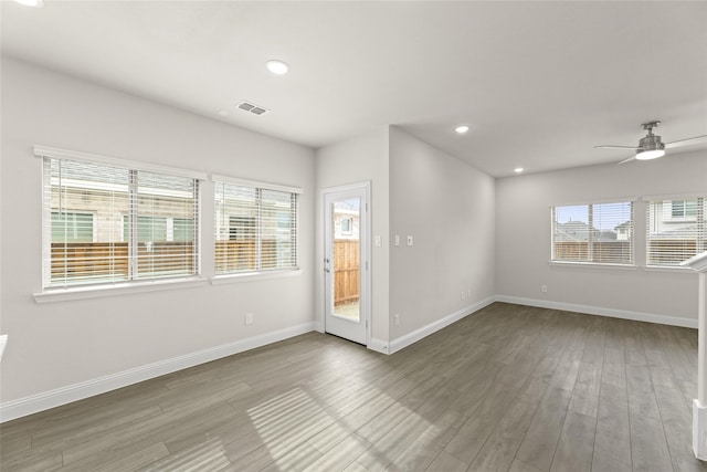 unfurnished room with hardwood / wood-style flooring and ceiling fan