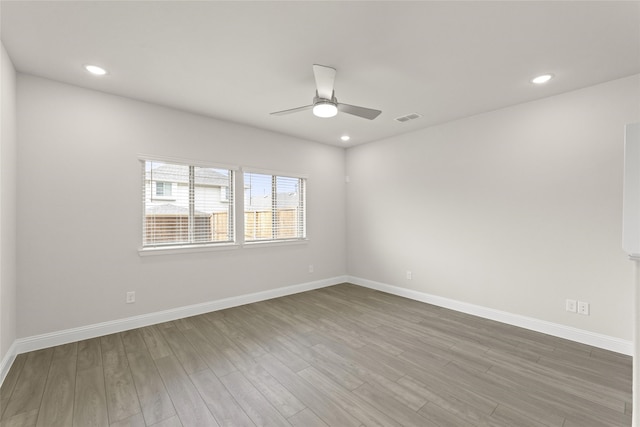 spare room featuring wood-type flooring and ceiling fan