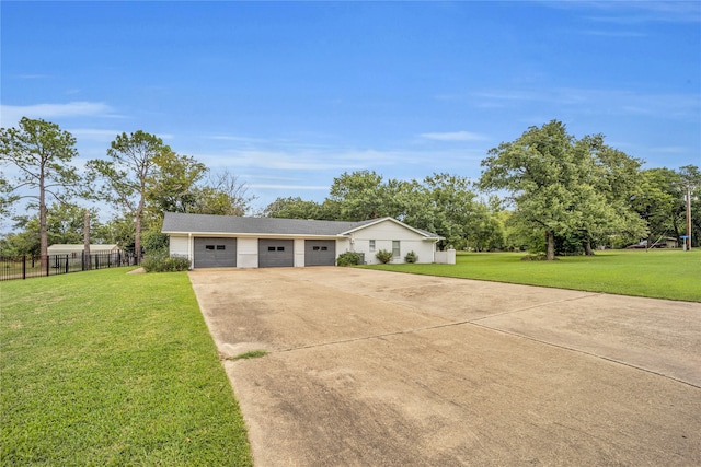 ranch-style home featuring a garage and a front lawn