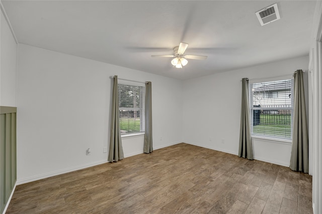 spare room with ceiling fan and wood-type flooring