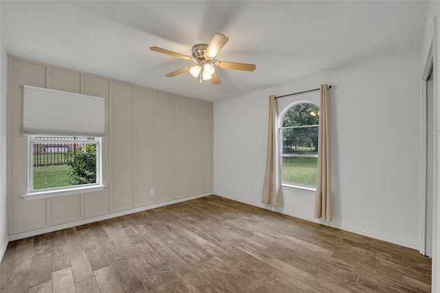 spare room featuring light hardwood / wood-style flooring and ceiling fan