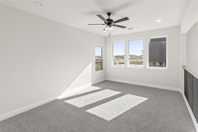 carpeted spare room with ceiling fan