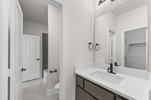 bathroom featuring toilet, tile patterned flooring, and vanity