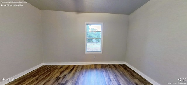 spare room featuring dark wood-type flooring