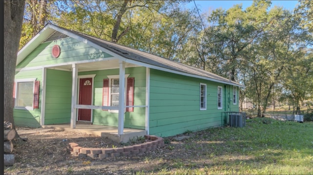 view of side of property with covered porch and central AC unit