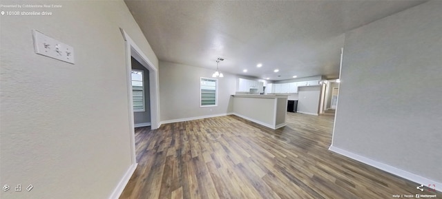 unfurnished living room with dark hardwood / wood-style floors