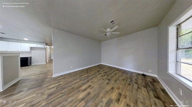 unfurnished room featuring ceiling fan and dark hardwood / wood-style flooring