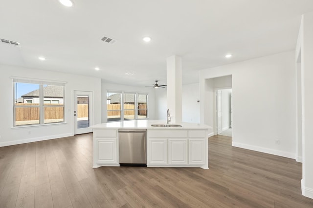 kitchen with a kitchen island with sink, sink, white cabinets, and dishwasher