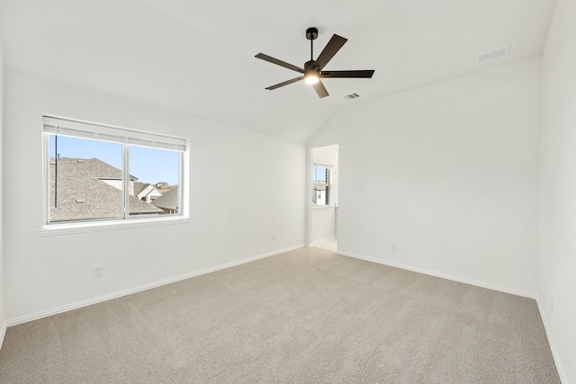 carpeted empty room with lofted ceiling and ceiling fan