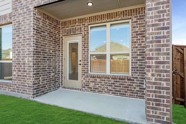 view of exterior entry featuring a patio